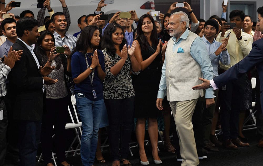 Prime Minister Narendra Modi is welcomed by employees of TESLA motors during a visit to its facility in San Jose.