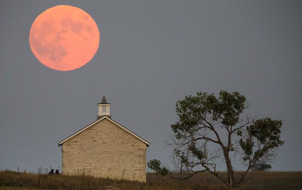 A super moon rises over the Lower Fox Creek School near Strong City, Kan.