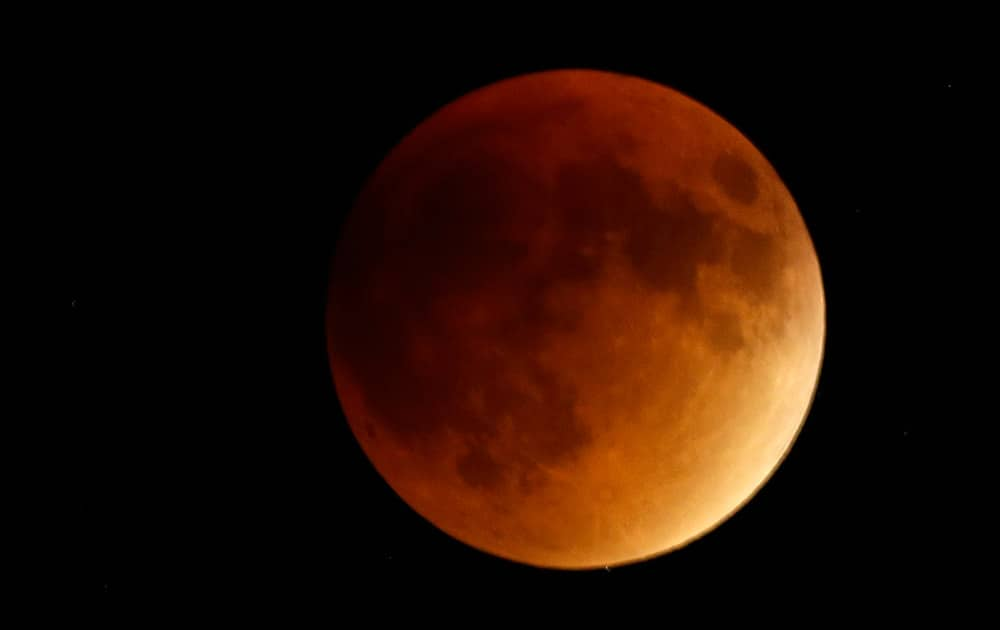 EARTH'S SHADOW OBSCURES THE VIEW OF A SO-CALLED SUPERMOON DURING A TOTAL LUNAR ECLIPSE NEAR LECOMPTON, KAN.