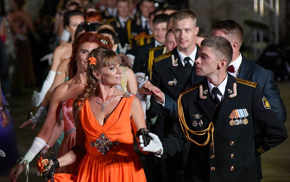 Russian Navy officers and their wives dance during an officers' ball inside the St. Michael Fortress in Sevastopol, Crimea.