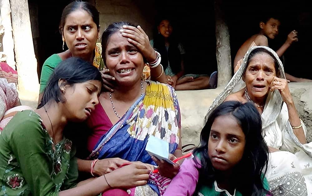 Relatives of hooch tragedy victims wail at Moina in East Midnapore district on West Bengal.