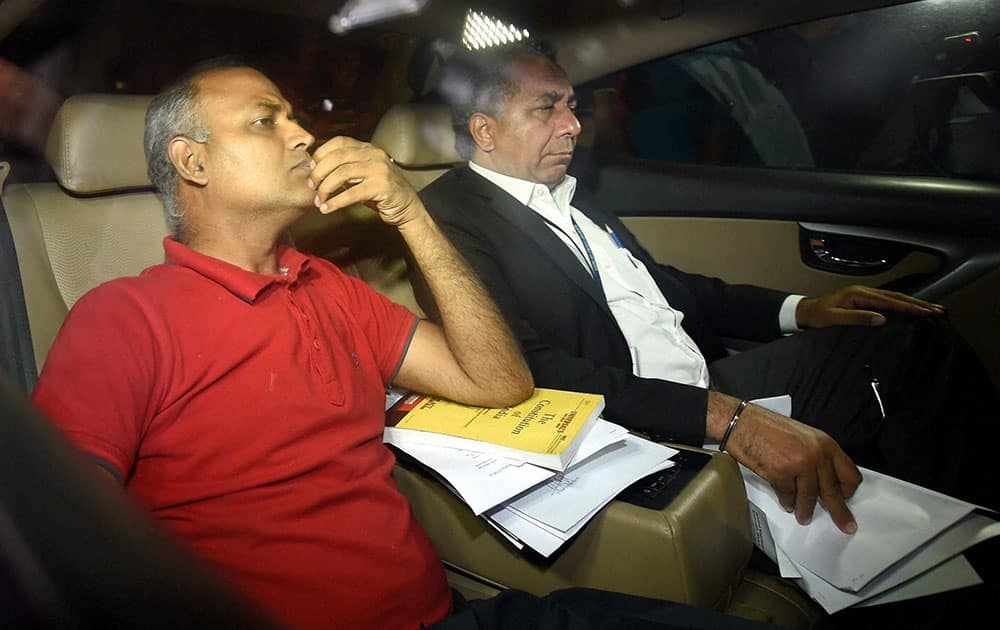 AAP MLA Somnath Bharti with his lawyer arrives to surrender at the Dwarka North Police Station in New Delhi.