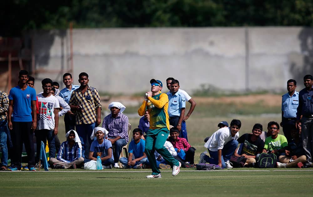 People watch as South Africa's David Miller takes a catch during a practice Twenty20 match against India A team in New Delhi.