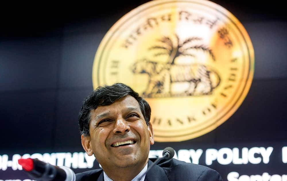 Reserve Bank of India governor Raghuram Rajan smiles during a press conference in Mumbai. India's central bank on Tuesday cut its key interest rate by half a percentage point, aiming to spur economic growth as inflation cooled to the lowest since November.