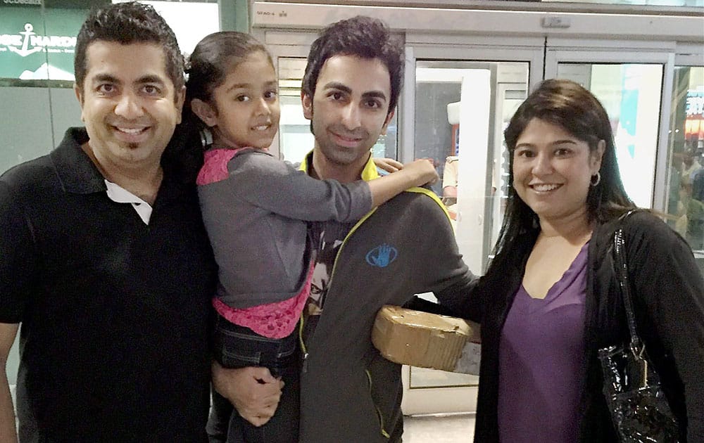 Cueist Pankaj Advani with his family upon his arrival at Bengaluru International Airport on Monday after winning his 14th world title in Adelaide. 