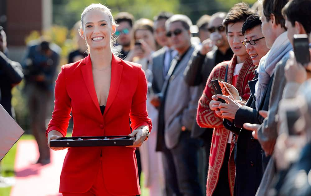 Israeli model Bar Refaeli brings the scissors for the ribbon cutting ceremony during the inauguration ceremony of an extension of the manufacture of the Swiss luxury watchmaker Hublot, owned subsidiary of France's LVMH, in Nyon, Switzerland.