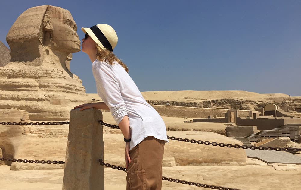 Bonnell poses so that she appears to be kissing the Sphinx, which stands in the background, in Giza, Egypt. 