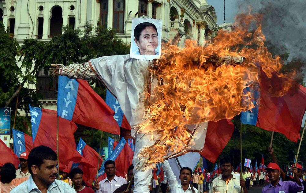 Members of AIYF burn effigy of West Bengal Chief Minister Mamata Banerjee during their protest against State Government in Kolkata.