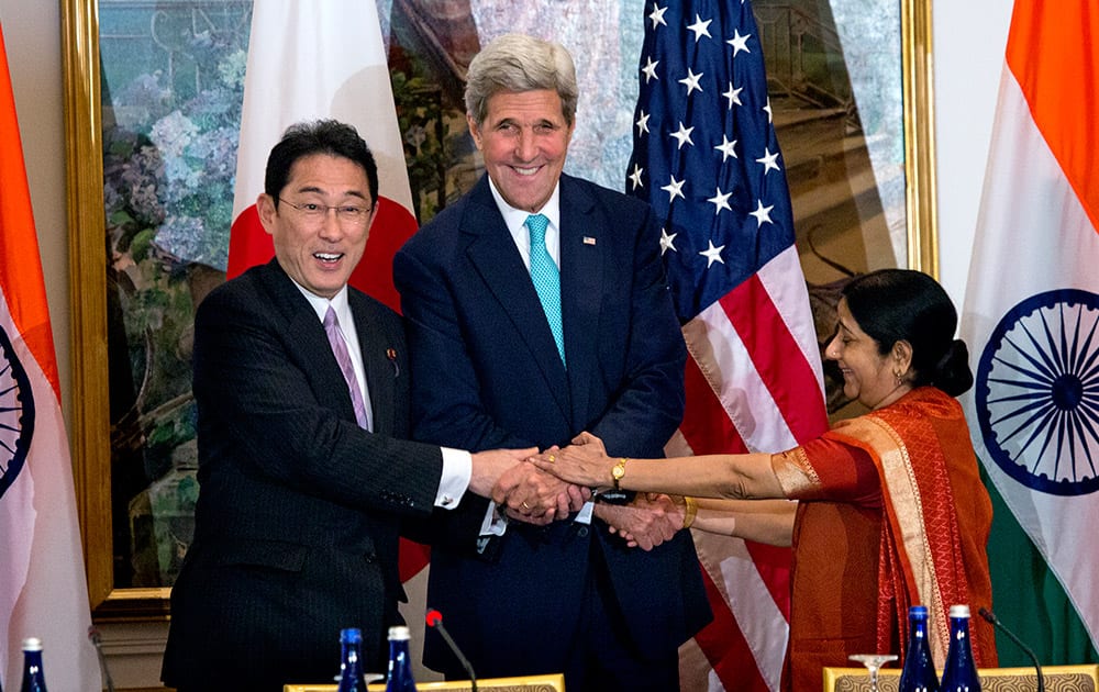 US Secretary of State John Kerry, shakes hands with Japan's Foreign Minister Fumio Kishida and India's External Affairs Minister Sushma Swaraj during a trilateral meeting, in New York.