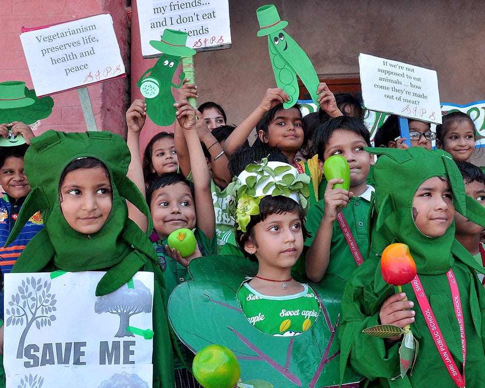 School children dressed in green giving the message Be Vegetarian on the occasion of World Vegetarian Day in Bikaner.