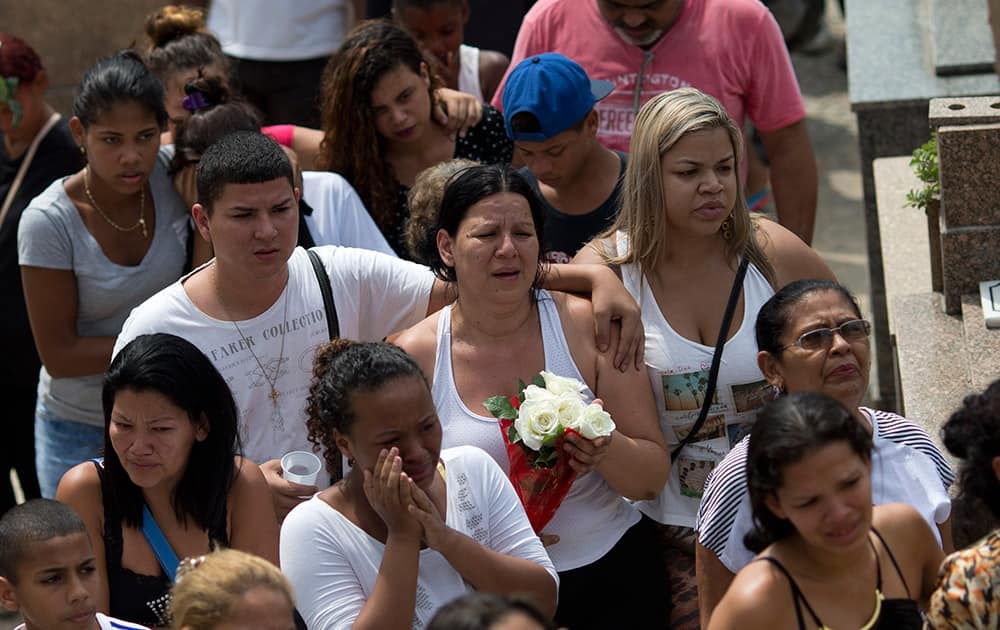 Relatives and friends of Eduardo Felipe Santos Victor, a teenager who was shot dead at Morro da Providencia favela, attend his burial service, in Rio de Janeiro, Brazil.