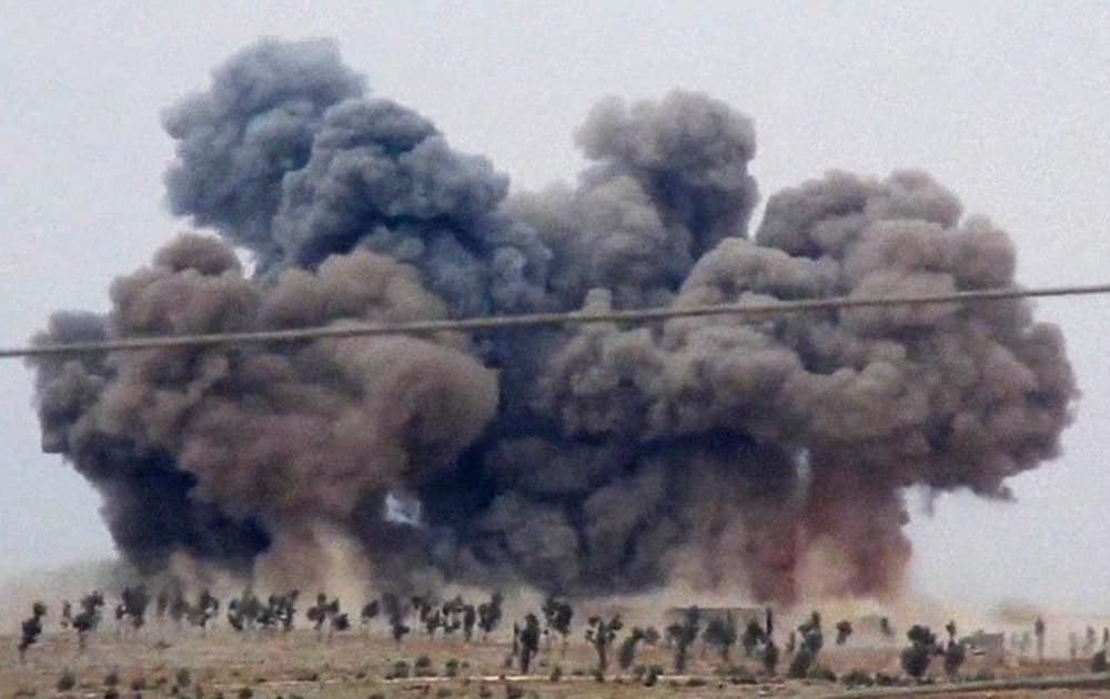 This image made from video provided by Hadi Al-Abdallah, which has been verified and is consistent with other AP reporting, smoke rises after airstrikes in Kafr Nabel of the Idlib province, western Syria.