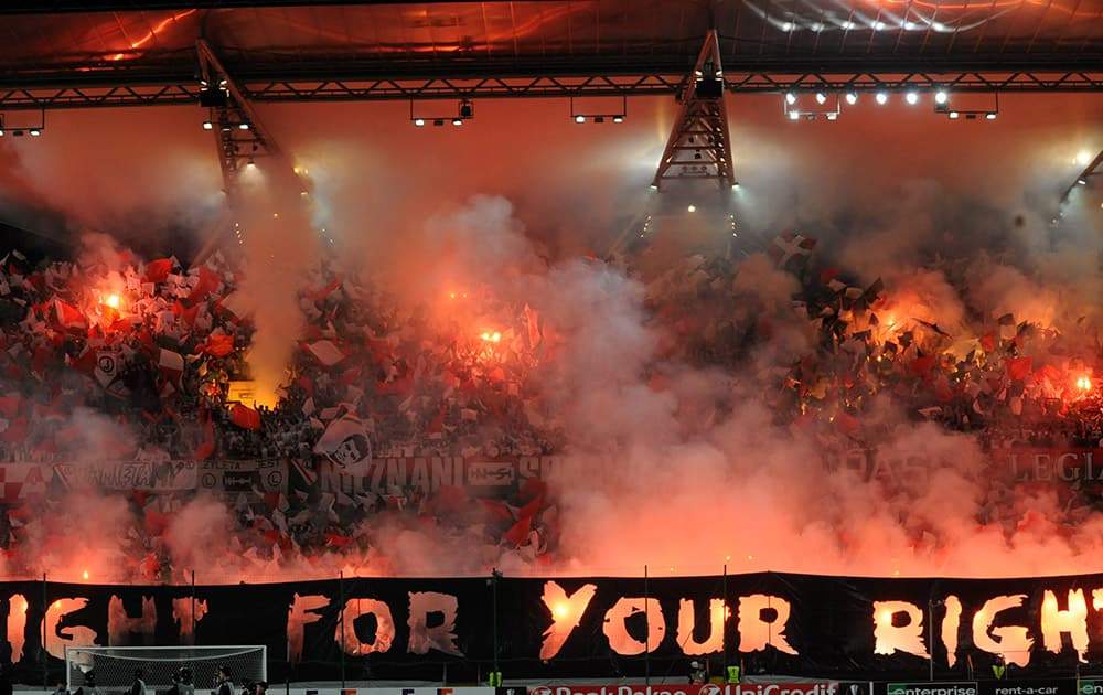 Legia Warszawa soccer fans burn flares prior to the Europa League group D soccer match between Legia Warszawa and SSC Napoli in Warsaw, Poland.