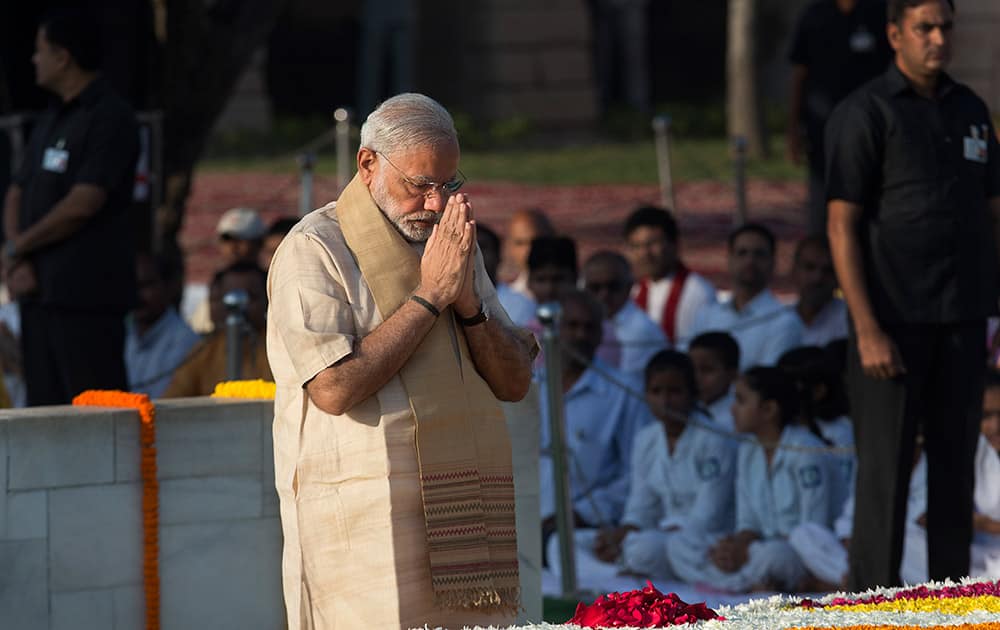 Prime Minister Narendra Modi pays tributes at the memorial of Mahatma Gandhi on the occasion of his birth anniversary, in New Delhi.