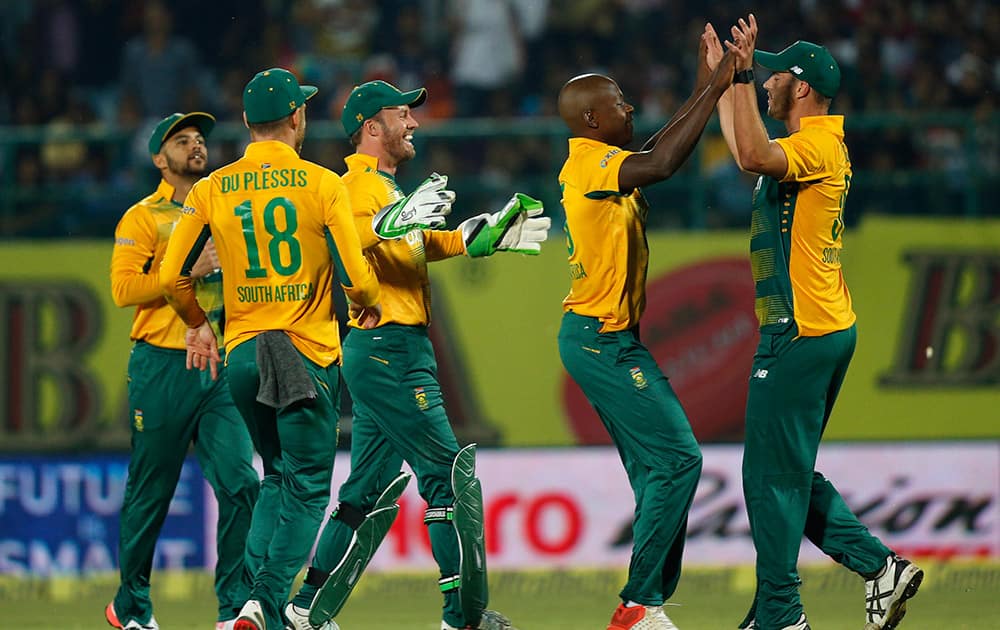 South African cricketers celebrate the dismissal of India's Shikhar Dhawan during the first Twenty20 cricket match between the two teams in Dharmsala.