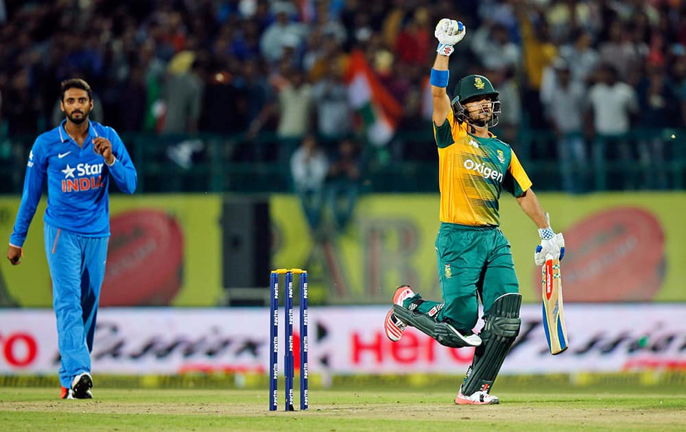 South Africa's Jean-Paul Duminy raises his hand as he completes the winning run during the first Twenty20 match against India in Dharmsala.