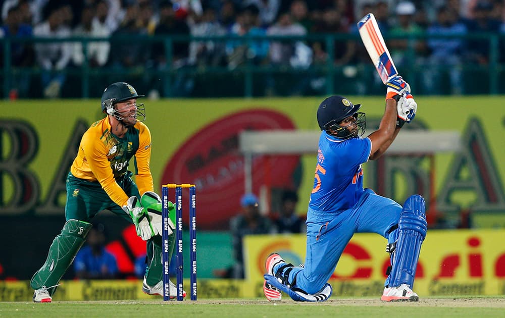 ROHIT SHARMA HITS A SIX DURING THE FIRST TWENTY20 CRICKET MATCH AGAINST SOUTH AFRICA IN DHARMSALA.