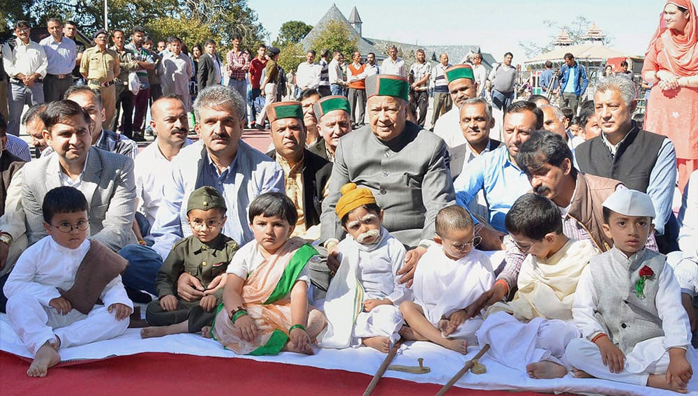 HP CM Virbhadra Singh poses with children dressed as prominent leaders of India during Gandhi Jayanti celebrations in Shimla.
