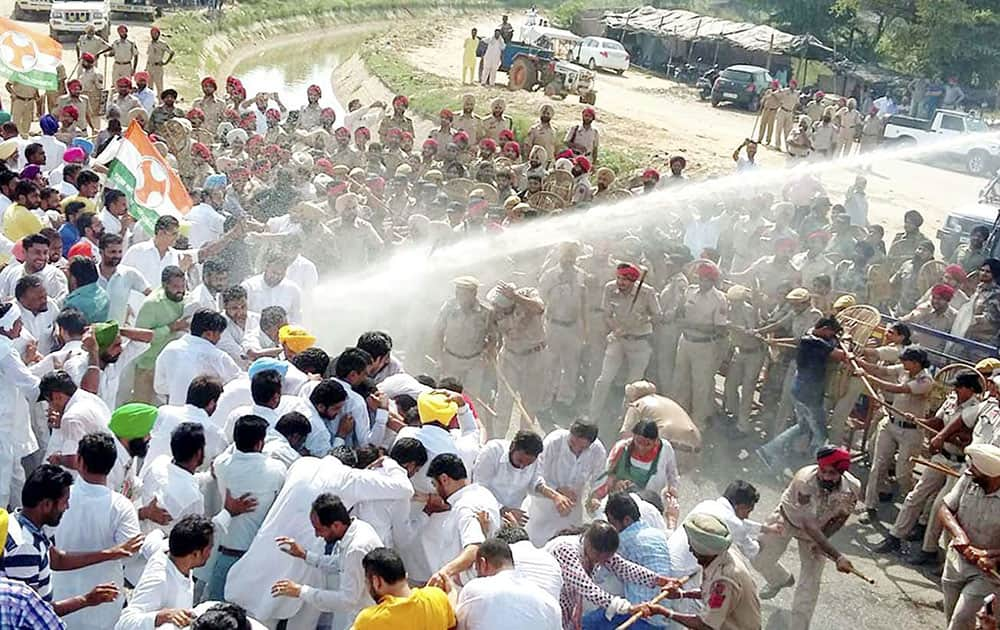 Police use water cannons to disperse the Congress workers, who were marching towards the residence of Punjab agriculture minister Tota Singh in Moga.
