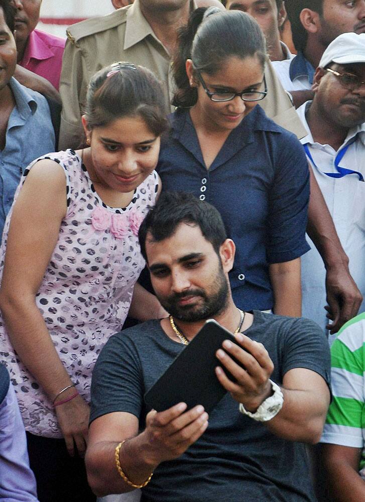 Indian player Mohd. Shami takes selfie with his fans during a Ranji match between Uttar Pradesh and Madhya Pradesh in Moradabad.