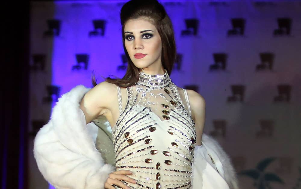 A model wears a dress designed by Iraqi designer Ziad Tariq during a fashion show at a Hotel in Basra, 340 miles (550 kilometers) southeast of Baghdad, Iraq.