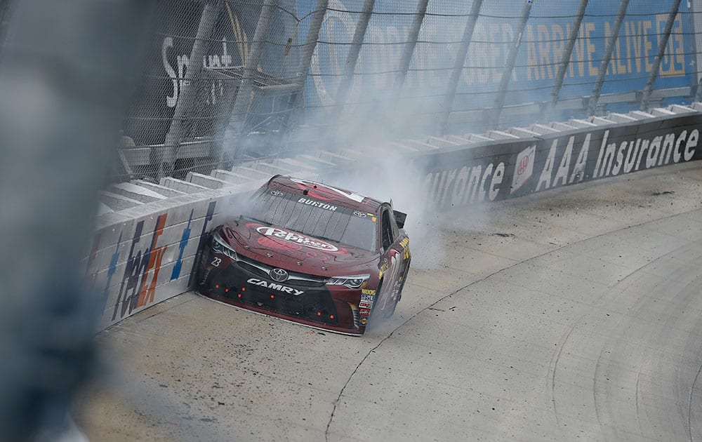 Jeb Burton crashes into the wall near turn two during the NASCAR Sprint Cup series auto race at Dover International Speedway in Dover, Del.