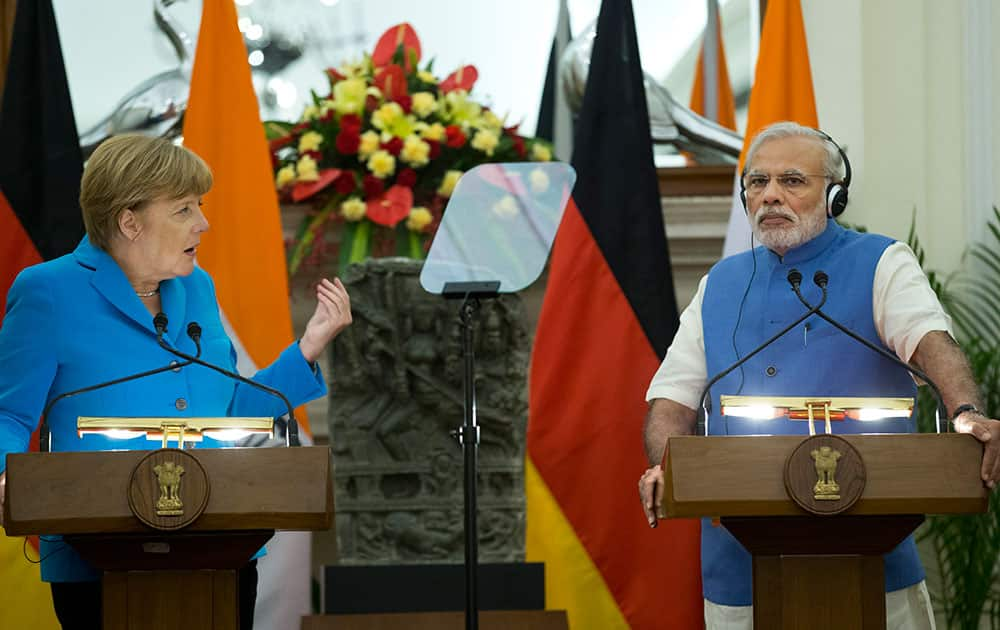 German Chancellor, Angela Merkel, left, and Indian Prime Minister, Narendra Modi, address the media in New Delhi.