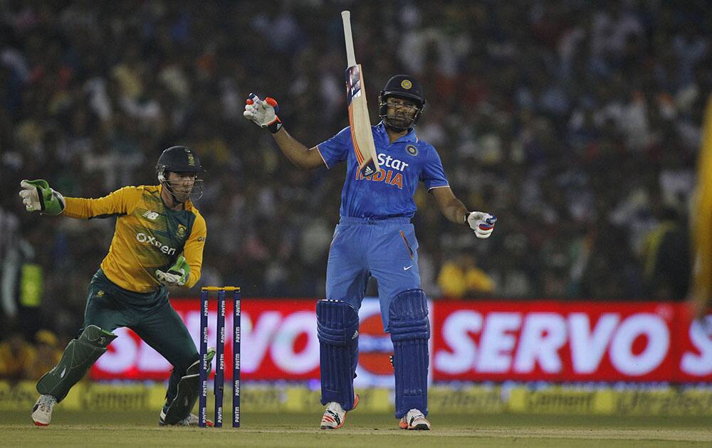 Rohit Sharma drops his bat while trying to play a delivery from South Africa's Imran Tahir during their second Twenty20 cricket match in Cuttack.