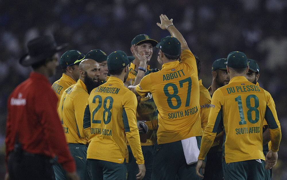 South African players celebrate after India's Virat Kohli was run out during their second Twenty20 cricket match in Cuttack.