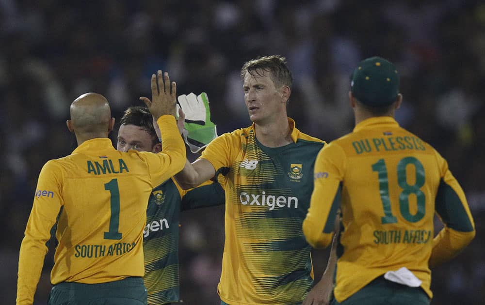 South Africa's Chris Morris celebrates the dismissal of India's Shikhar Dhawan during their second Twenty20 cricket match in Cuttack.
