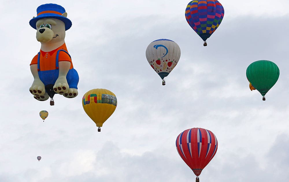 A special shaped hot air balloon flies among others during the 44th International Balloon Fiesta in Albuquerque, N.M.