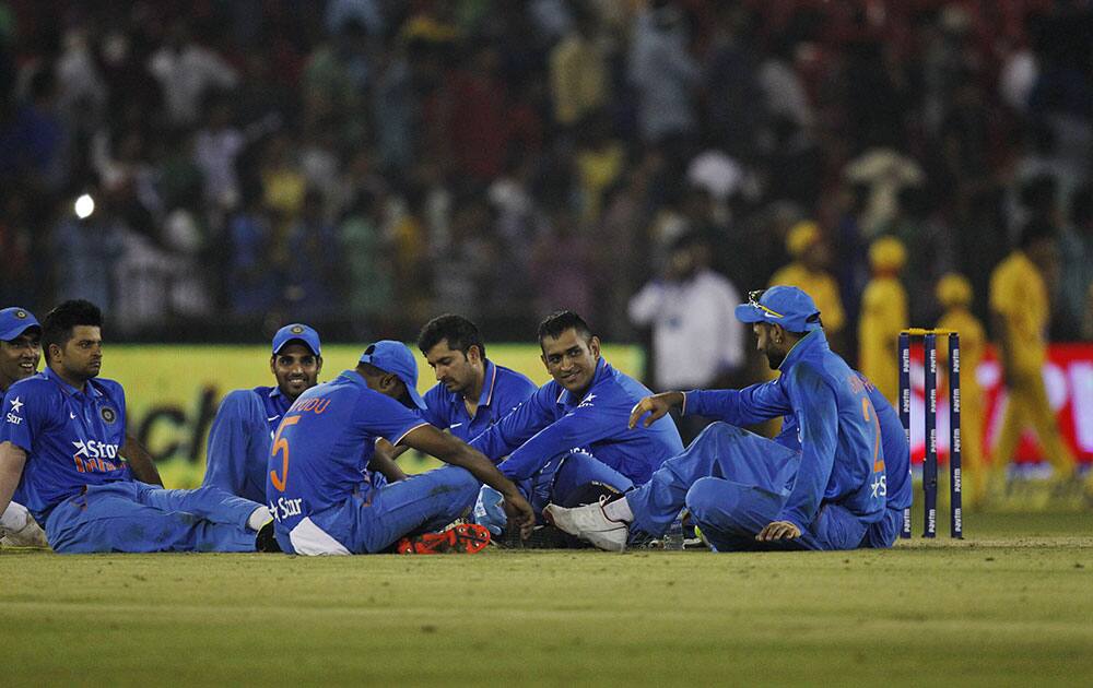 Indian players sit in the ground as their second Twenty20 cricket match against South Africa is disrupted after spectators threw water bottles in Cuttack.