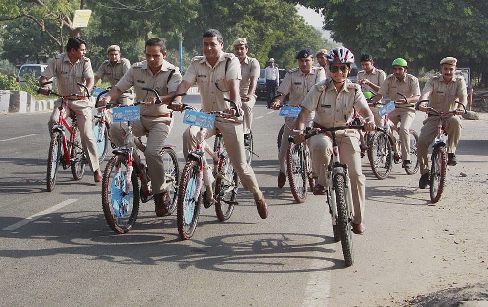 Police officials riding bicycles to create awareness for car free day in Gurgaon.