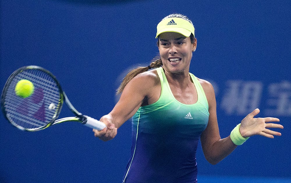 Ana Ivanovic of Serbia hits a return shot against Venus Williams of the United States during the second round women's singles match of the China Open tennis tournament at the National Tennis Stadium in Beijing.