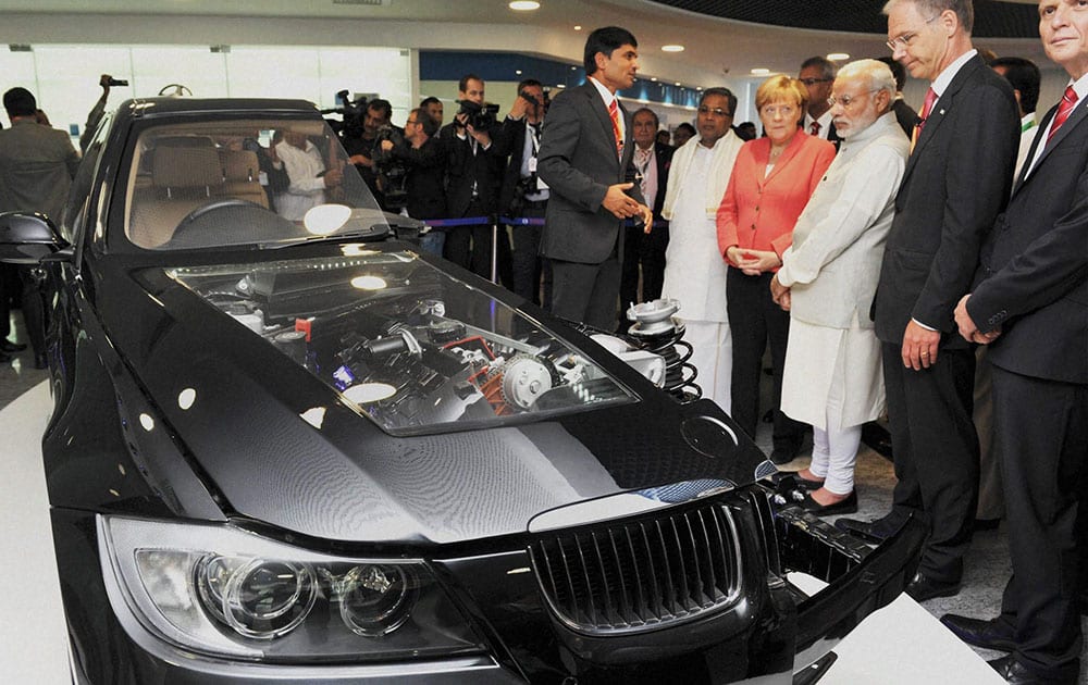 Prime Minister Narendra Modi and German Chancellor Angela Merkel during their visit to Robert Bosch Engineering & Innovation Centre in Bengaluru.