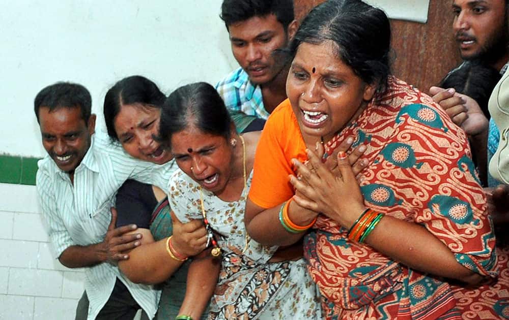 Relatives mourn the death of people in a collision between a bus and a lorry in Ramannapeta of Nalgonda district.