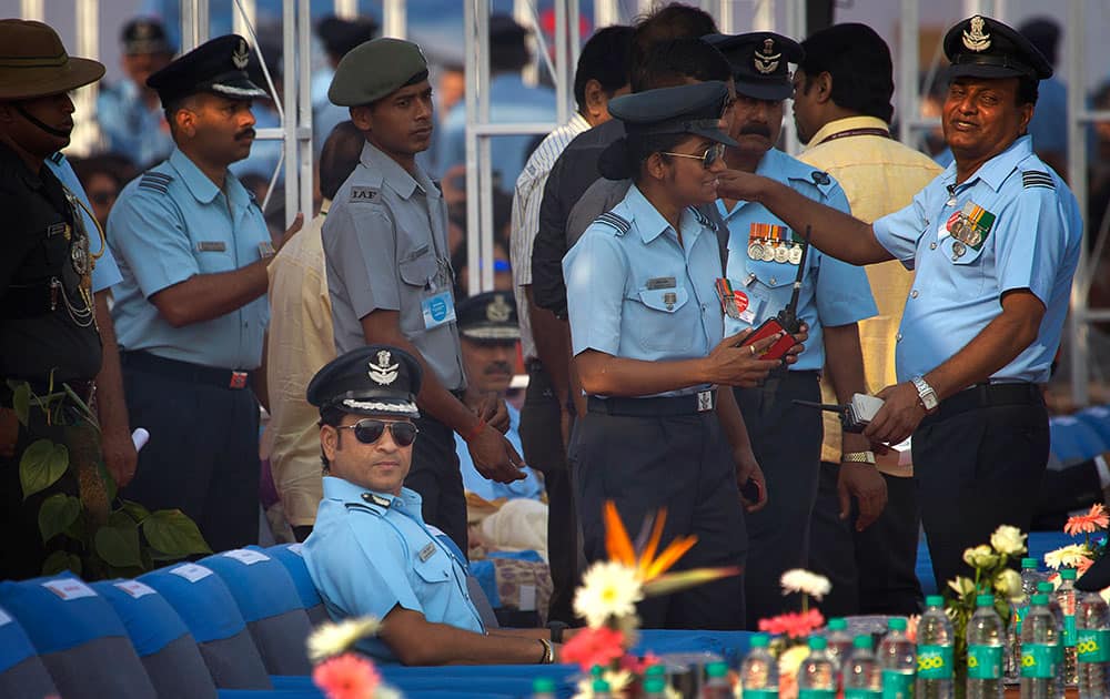 Former Indian cricketer and honorary Indian Air Force (IAF) officer Sachin Tendulkar, seated, attends the Air Force Day parade at Hindon Air Force base near New Delhi.