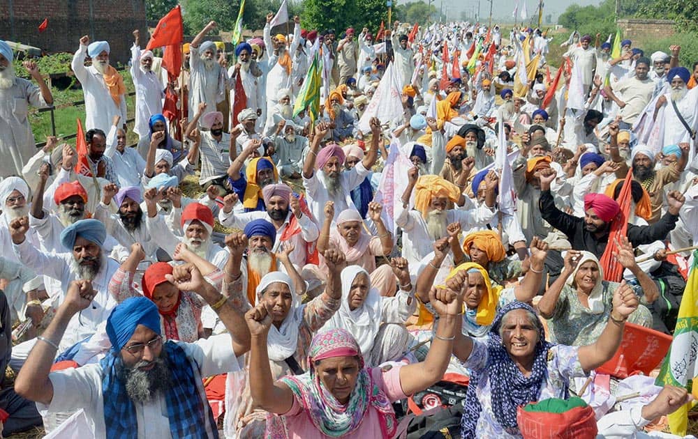 Farmers blocking rail traffic at Khalchian village near Amritsar in protest against poor price of rice.