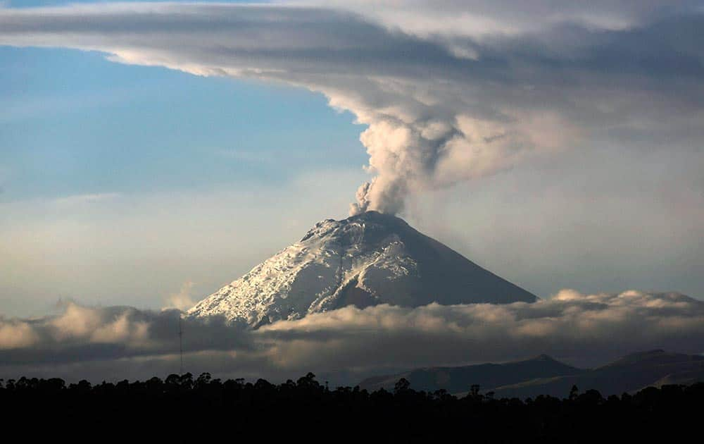 A large plume of ash and steam rises from the Cotopaxi volcano as seen from Quito, Ecuador.