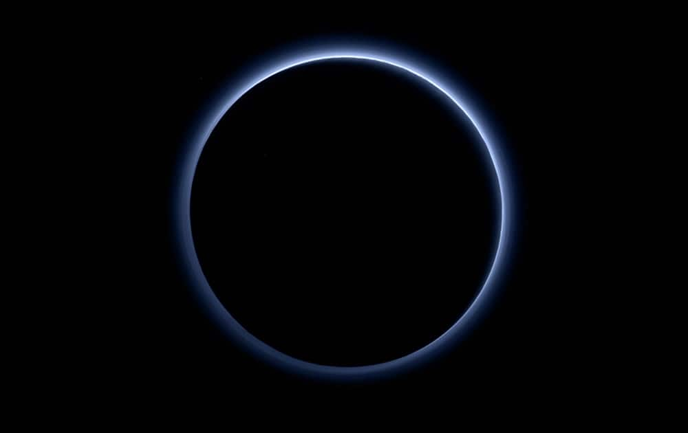 This image released by NASA, shows the blue color of Pluto’s haze layer in this picture taken by the New Horizons spacecrafts Ralph/Multispectral Visible Imaging Camera (MVIC).