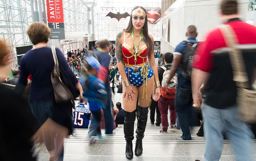 An attendee dressed as Wonder Woman walks the floor of New York Comic Con at the Javits Center, in New York. .