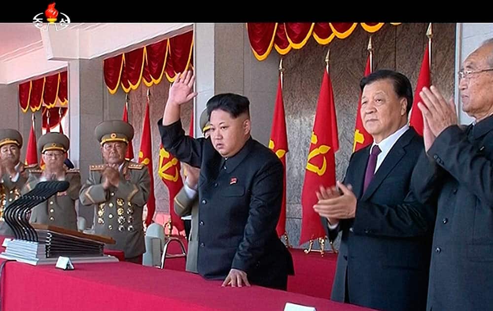 North Korean leader Kim Jong Un, along with Liu Yunshan, Chinas Communist Partys No. 5 leader, waves during the ceremony to mark the 70th anniversary of the countrys ruling party in Pyongyang.