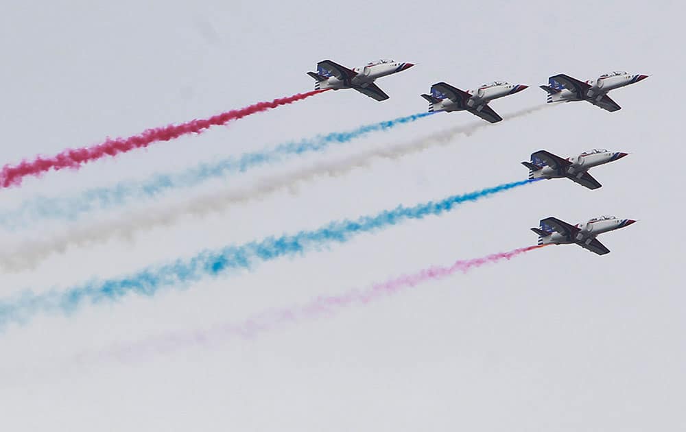 Taiwan air force AT-3 jets, trailing colored smoke, fly over head during the National Day celebrations in Taipei, Taiwan.