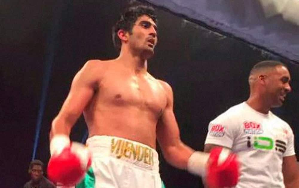 Indian boxer Vijender Singh celebrates after winning the match against Englands Sonny Whiting during first professional boxing bout at Manchester Arena, UK.