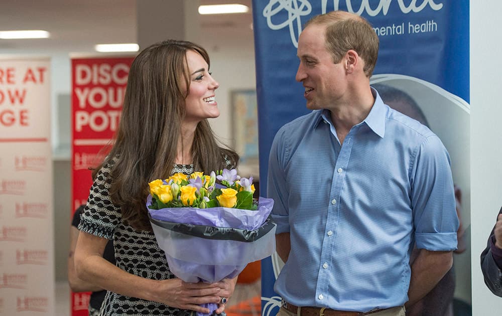 Britains Prince William and Kate, the Duke and Duchess of Cambridge, smile at each other as they attend an event marking World Mental Health Day hosted by Mind, at Harrow College, in Middlesex, England.