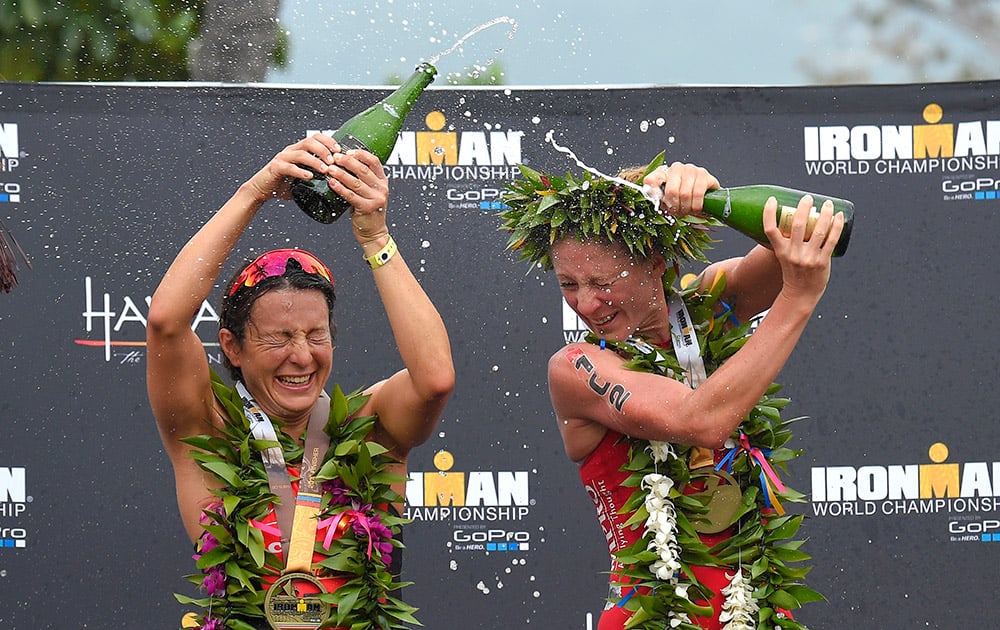 Women's second place winner, Rachel Joyce, left, of Great Britain, and first place winner Daniela Ryf, of Switzerland, douse each other after the Ironman World Championship Triathlon.