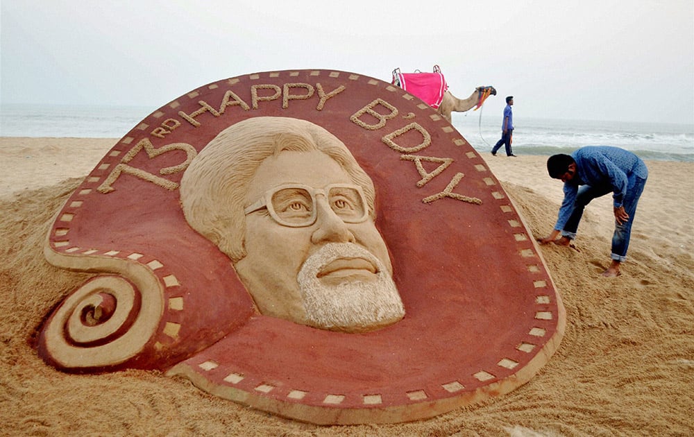 Sand artist Sudarsan Pattnaik creates a sand image of actor Amitabh Bachchan on the occasion of 73rd birthday, at Puri beach.
