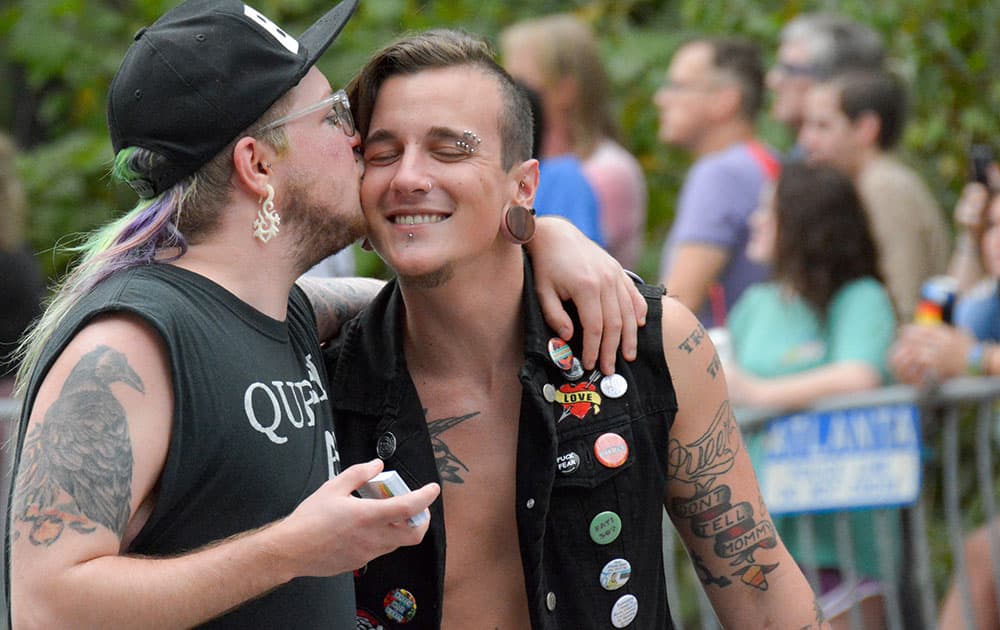 Two men hug during the annual Atlanta Gay Pride parade.