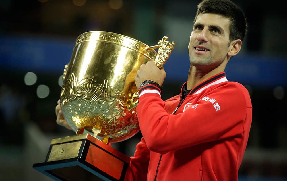 Novak Djokovic of Serbia holds the winners trophy after beating Rafael Nadal of Spain in their mens singles final match in the China Open tennis tournament.
