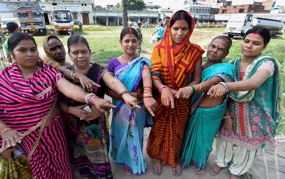 Voters show their inked fingers after casting votes for Bihar assembly elections in Begusarai.